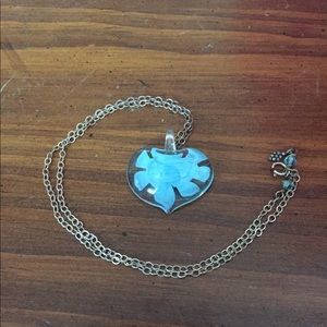 Glass heart pendant with blue flower inside